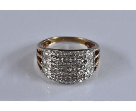 A diamond pave encrusted ring, tapering white gold and diamond crest, set with nine rows of nine diamonds, total estimated di
