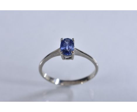 A tanzanite solitaire ring, oval pale purple/blue tanzanite approx 0.20ct, 18ct white gold shank, stamped 750, size M, 1.7g g