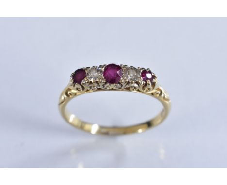 A diamond and ruby five stone line ring, alternate set with three oval red rubies and two round cut diamonds, total estimated