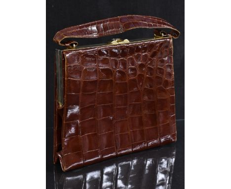 A framed crocodile handbag, Sackville model by Bagcraft of London, top handle, gilt metal fittings, tan suede interior