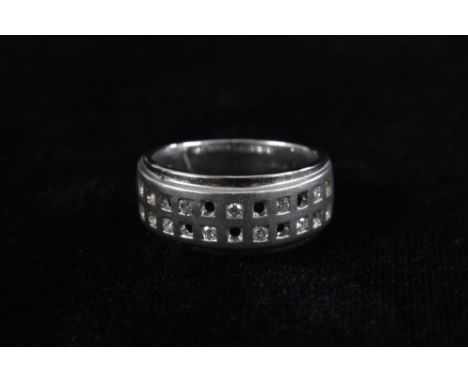 A diamond checkerboard band ring, brushed double row checkered panel irregularly inset with eight round brilliant cut diamond