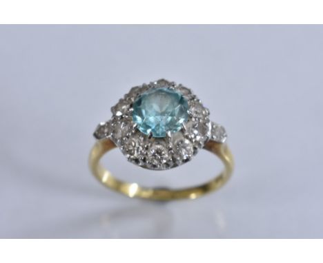 A diamond and pale blue tourmaline cluster ring, central pale blue round cut tourmaline, surrounded by a band of ten round ol