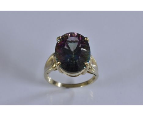 A mystic topaz solitaire ring, oval stone flashing purple, green, orange and red, total estimated stone weight approx 8.0ct, 