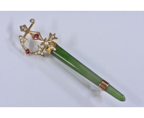 A late 19th century stick pin as a ceremonial sword, 9ct gold hilt set with seed pearls and red stones, polished jade blade, 