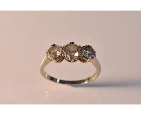 A diamond trilogy ring, central round brilliant cut diamond approx 0.35ct, flanked by a smaller conforming diamond to either 