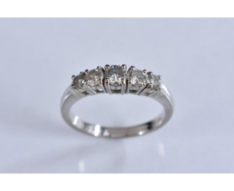 A contemporary five stone diamond ring, set with a stepped row of graduated round brilliant cut diamonds, total estimated dia