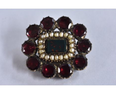 A George III blood stone, seed pearl and garnet brooch, central blood stone panel surrounded by a band of twenty seed pearls,
