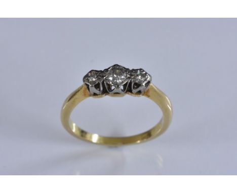 A diamond trilogy ring, linear set with three round brilliant cut diamonds, total estimated diamond weight approx 0.18ct, 18c