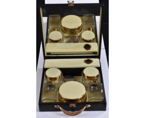 A compact Sirram lady's travelling vanity case, matte black finish, bronzed metal fittings, fitted interior, glass and gilt m
