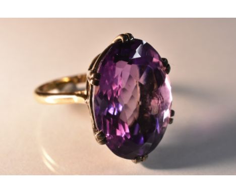 A large amethyst solitaire ring, oval cut amethyst approx 17ct, six double claw basket, 9ct gold shank, stamped 9c, size Q, 8