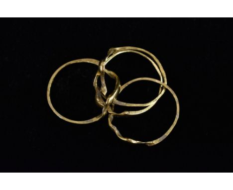 An 18ct gold four section undulating puzzle ring, size L, stamped 750, 4.4g