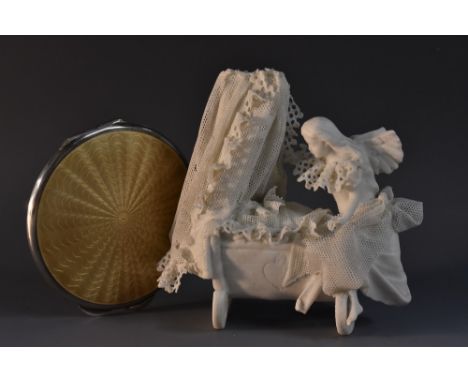 A lady's silver compact, engine turned starburst design, buff enamel, William Neale & Sons 1947, in soft pouch; a white bisqu