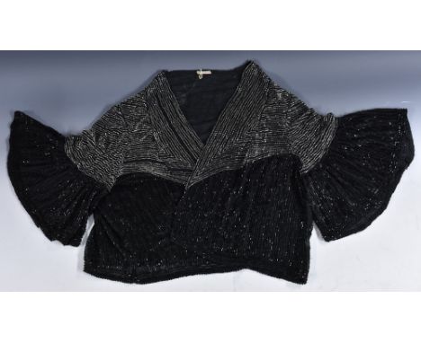 A 1920s French beaded bolero style evening jacket, bell sleeves, clear and black bugle beads on black chiffon