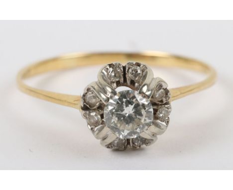 A gold (unmarked) and diamond set ring, central diamond with smaller diamonds on layer below, 2.2g, in box