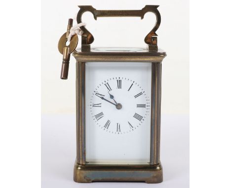 A small early 20th century brass carriage clock, white enamel dial with Roman numerals, bevelled glass, 7.5cmWx10.5cmH