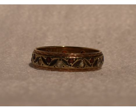 A lady's eternity ring having red and white paste decoration in a decorative 9ct gold band, size M &amp; approx 2.6g