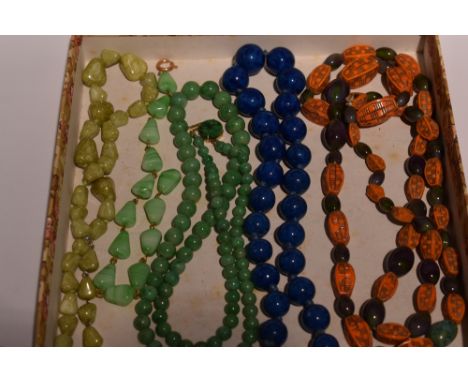 Four vintage strings of beads including a short string of Lapis Lazuli, green marble, jadeite style beads with yellow metal c