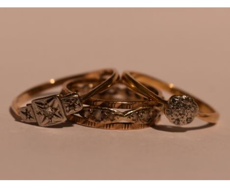 A lady's dress ring having a diamond chip cushion cluster on a yellow metal loop stamped 18ct, another similar ring on a yell