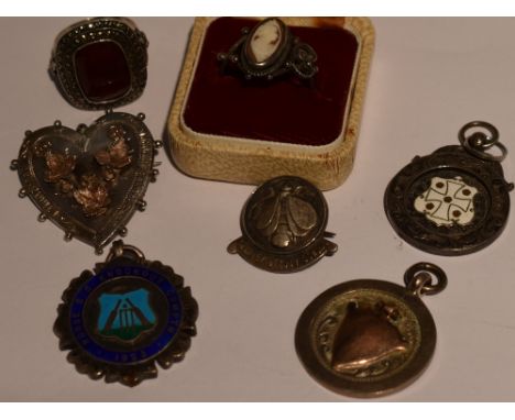 A small selection of HM silver and white metal including a cameo ring, marcasite ring and medalions