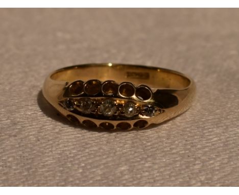 A lady's dress ring having five small old cut diamonds in a pave set boat mount on a yellow metal loop stamped 18ct, size P &