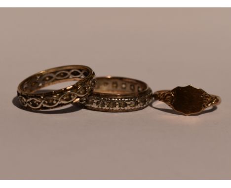 Two lady's eternity rings having white paste stones in white and yellow metal bands stamped 9ct and silver, sizes P, and a 9c