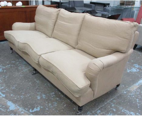 GEORGE SMITH SOFA, three seater, with neutral upholstery on short turned front supports with castors, 226cm L. (with faults)