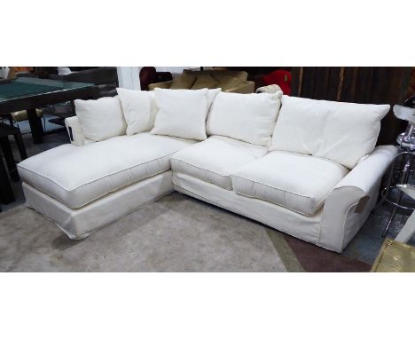 CORNER SOFA, in a white loose cover by Collins & Hayes. 275cm x 210cm x 77cm H.