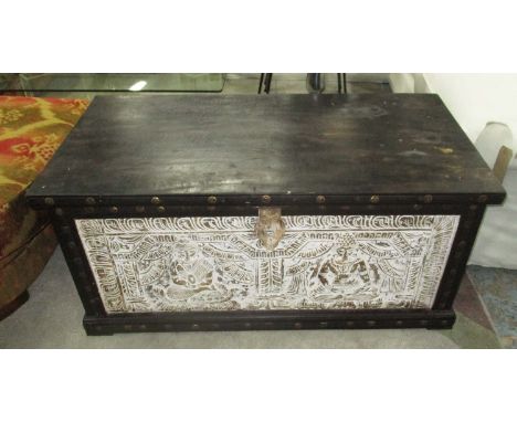 TRUNK, with a rising lid and carved front panel with studded detail, 56cm D x 54cm H x 113cm W.