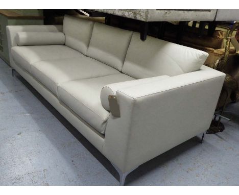 SOFA, three seater, with cream leather upholstery and two bolster cushions, 243cm L.