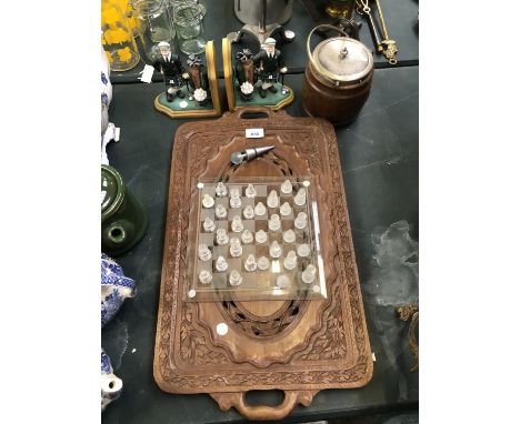 A CARVED WOODEN DRINKS TRAY, GOLFER BOOKENDS, BISCUIT BARREL AND CHESS SET 
