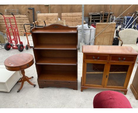 THREE ITEMS - A YEW WOOD DRUM TABLE, A MAHOGANY BOOK SHELF AND A YEW WOOD HALL CABINET WITH TWO DOORS AND TWO DRAWERS 