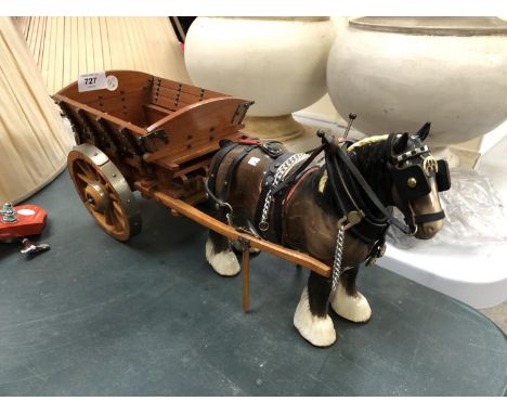 A CERAMIC BROWN GLOSS MODEL SHIRE HORSE AND WOODEN CART 