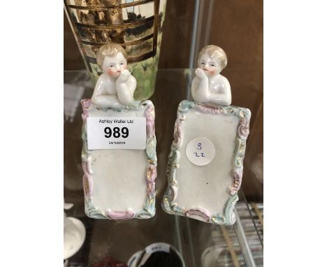 A PAIR OF CERAMIC CONTINENTAL CHERUB PLAQUES 