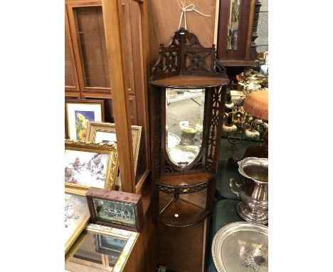 A MAHOGANY HANGING SHELF UNIT WITH MIRRORED PANEL 