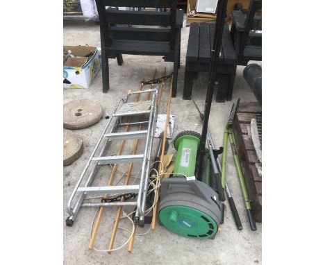A COLLECTION OF GARDEN TOOLS TO INCLUDE A HOSEPIPE ON A REEL, A THREE STEP ALUMINIUM STEP LADDER, A FERTILIZER SPREADER, SHEA