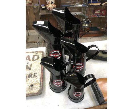 A GRADUATED SET OF FIVE METAL 'HARLEY DAVIDSON' PETROL CANS 