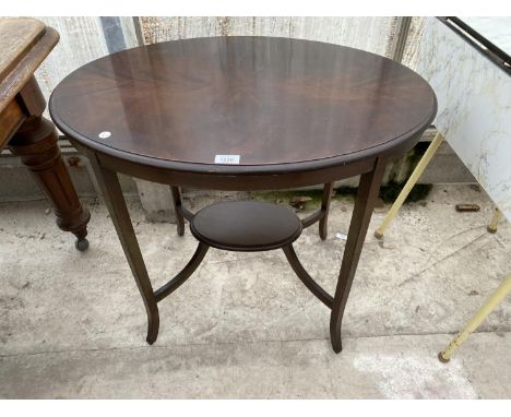 AN OVAL MAHOGANY SIDE TABLE WITH LOWER SHELF 