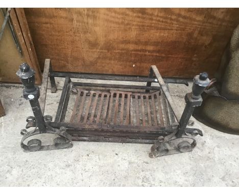 A CAST IRON FIRE GRATE WITH ORNATE STANDS 