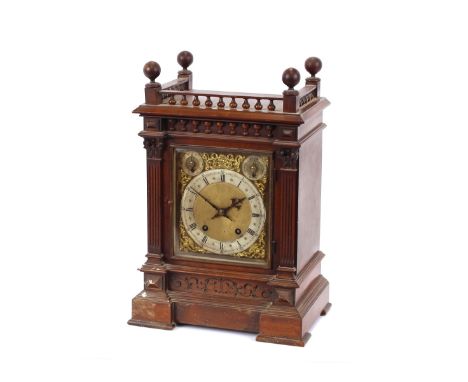 A Victorian walnut cased chiming mantel clock, having brass spandril dial and steel chapter ring, surmounted by a pierced gal