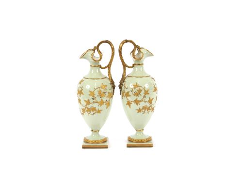 A pair of Grainger &amp; Co., Worcester baluster ewers, having rich gilt foliate decoration on a pale green ground, 30cm high