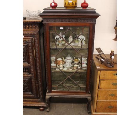 A mahogany Chippendale style display cabinet, having blind fret decoration, the fabric lined shelves enclosed by a single gla