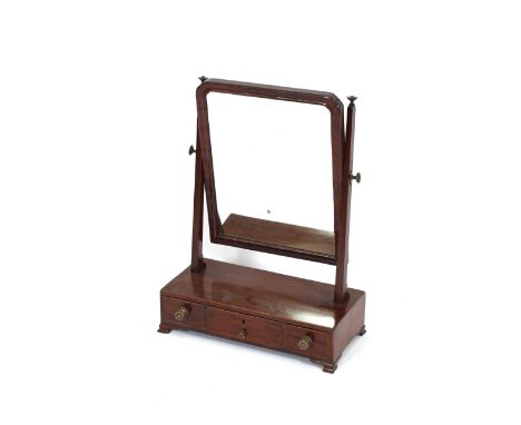 A 19th Century mahogany swing toilet mirror, raised on three drawer box base, terminating in ogee bracket supports, 40cm wide