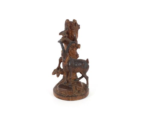 A 19th Century carved softwood Black Forest spill holder,&nbsp;in the form of a dead tree trunk surmounted by an Alpine Ibex 