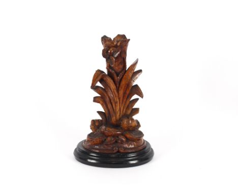 A 19th Century carved softwood Black Forest spill holder, in the form of a tree trunk flanked by grasses and stepped stones o