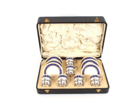 A cased set of six Royal Worcester coffee cans and saucers, the cans with silver holders, hallmarked&nbsp;London 1911