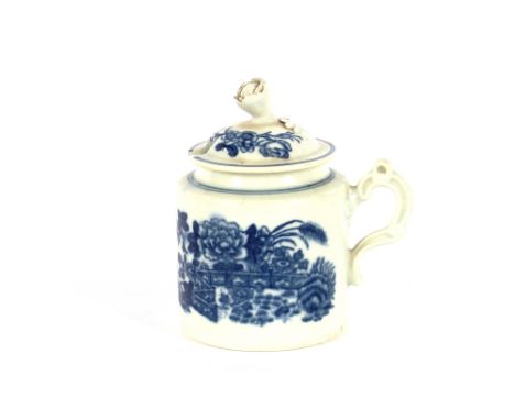 An 18th Century Worcester mustard pot, the cover with flower finial and scroll handle, decorated with fence pattern, under-gl