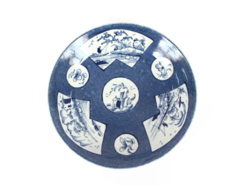 An 18th Century shallow Worcester dish, decorated with vignette panels, in the Chinese manner, 18cm dia.