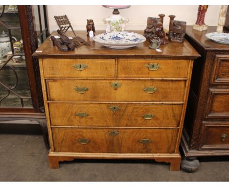 An 18th Century walnut chest, fitted two short over three long drawers, on bracket feet, 97cm wide