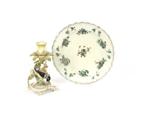 A 19th Century porcelain floral encrusted candlestick, with bird decoration on a scrolled base heightened in gilt, 17cm high;