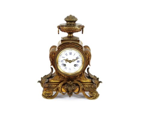 A French gilded metal mantel clock,&nbsp;by Hersant Paris No. 4871, surmounted by an urn finial above a circular blue enamel 